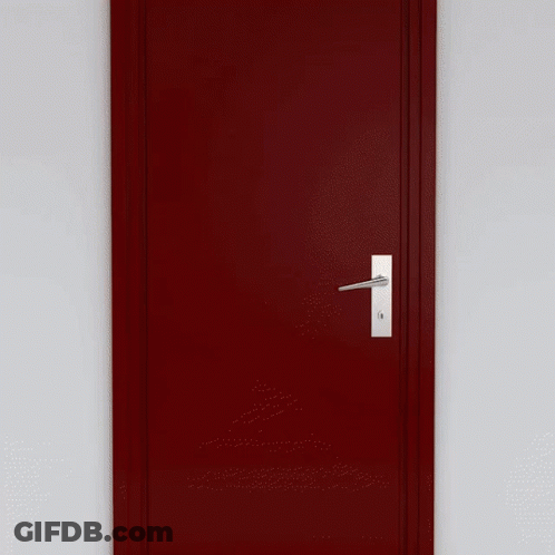 A Man In A Suit And Tie Is Standing In Front Of An Open Door GIF
