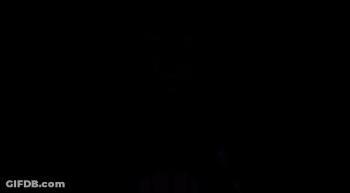 A Man In A Suit And Tie Is Standing In The Dark With His Mouth Open And The Words `` No '' Coming Out Of His Mouth . GIF