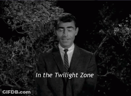 A Man In A Suit And Tie Is Standing In The Twilight Zone . GIF