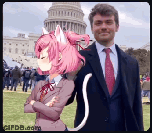 A Man In A Suit And Tie Is Standing Next To A Girl With Pink Hair And Cat Ears GIF