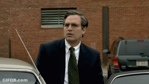 A Man In A Suit And Tie Is Standing Next To A Jeep Wrangler GIF