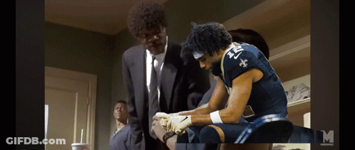 A Man In A Suit And Tie Is Standing Next To A Man In A Blue Jersey With The Number 21 On It GIF