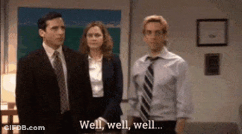 A Man In A Suit And Tie Is Standing Next To A Woman And A Man In A Suit And Tie . GIF