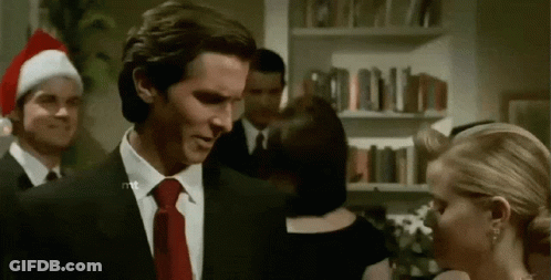 A Man In A Suit And Tie Is Standing Next To A Woman . GIF