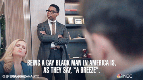 A Man In A Suit And Tie Is Standing Next To A Woman In A Blue Jacket With The Caption Being A Gay Black Man In America GIF