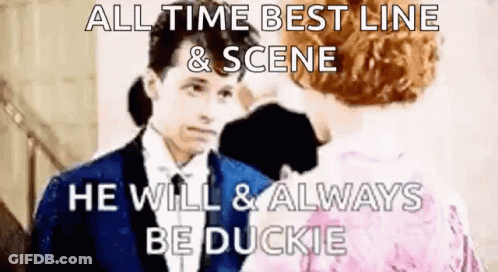 Man In Suit Talking To Woman In Pink Dress GIF