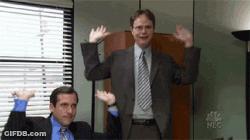 Man In Suit And Tie With Arms In Air GIF