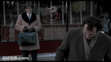 A Man In A Suit And Tie Is Standing Next To Another Man In A Suit And Tie . GIF