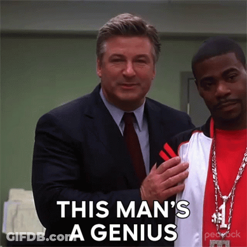 A Man In A Suit And Tie Is Standing Next To Another Man With The Words This Man 'S A Genius On The Bottom GIF