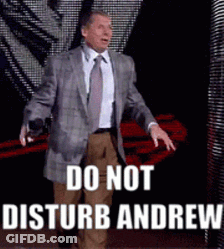 A Man In A Suit And Tie Is Standing On A Stage And Says Do Not Disturb Andrew GIF