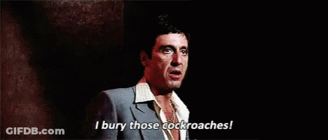 A Man In A Suit And Tie Is Standing On A Stage And Talking . GIF