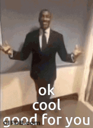 A Man In A Suit And Tie Is Standing With His Arms Outstretched And The Words `` Ok Cool Good For You '' . GIF