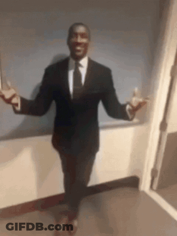A Man In A Suit And Tie Is Standing With His Arms Outstretched . GIF