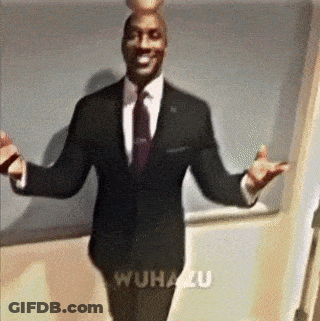 A Man In A Suit And Tie Is Standing With His Arms Outstretched In Front Of A Wall That Says Wuhanzu GIF