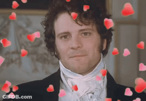 A Man In A Suit And Tie Is Surrounded By Red Hearts GIF