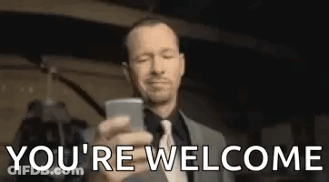 A Man In A Suit And Tie Is Taking A Picture Of Himself With His Cell Phone . GIF