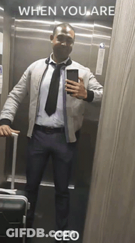 A Man In A Suit And Tie Is Taking A Selfie In An Elevator With The Caption When You Are Ceo . GIF
