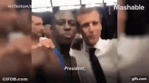 A Man In A Suit And Tie Is Taking A Selfie With A Man In A Suit And Tie . GIF