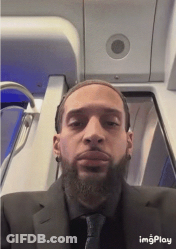 A Man In A Suit And Tie Is Taking A Selfie With Imgplay Written On The Bottom GIF