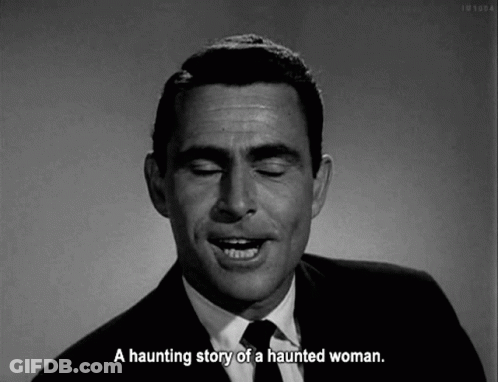 A Man In A Suit And Tie Is Talking About A Haunting Story Of A Haunted Woman . GIF