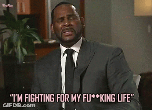 A Man In A Suit And Tie Is Talking About Fighting For His King Life . GIF