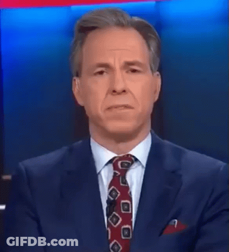 A Man In A Suit And Tie Is Talking About Something That Was A Hot Mess Inside A Dumpster GIF