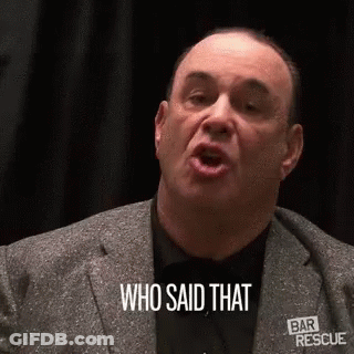 A Man In A Suit And Tie Is Talking And Saying `` Who Said That '' . GIF