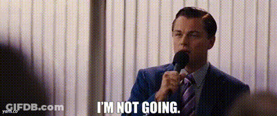 A Man In A Suit And Tie Is Talking Into A Microphone And Saying `` I 'M Not Going '' . GIF