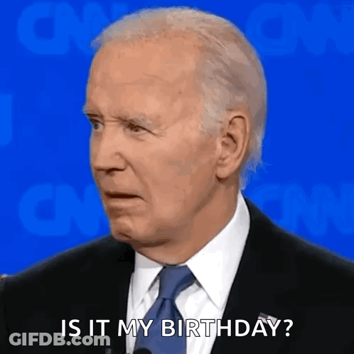 A Man In A Suit And Tie Is Talking Into A Microphone And Saying `` Is It My Birthday ? '' GIF