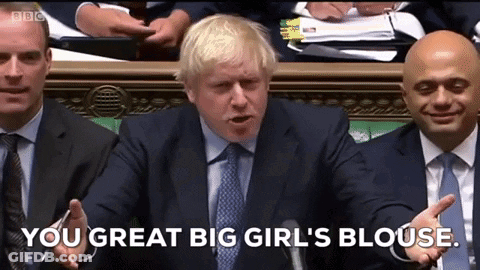 A Man In A Suit And Tie Is Talking Into A Microphone And Says " You Great Big Girl 'S Blouse " . GIF