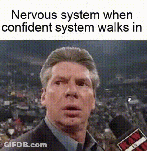 A Man In A Suit And Tie Is Talking Into A Microphone While A Nervous System When Confident System Walks In . GIF