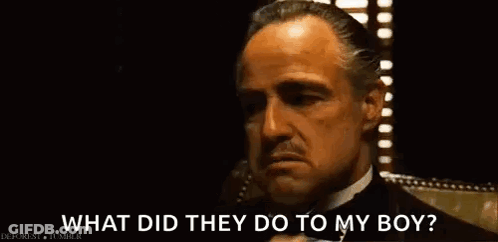 A Man In A Suit And Tie Is Talking On A Cell Phone And Asking What Did They Do To My Boy . GIF