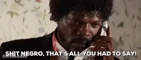 A Man In A Suit And Tie Is Talking On A Cell Phone And Making A Funny Face . GIF