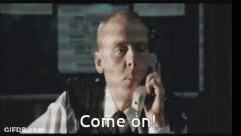 A Man In A Suit And Tie Is Talking On A Cell Phone And Says Come On . GIF