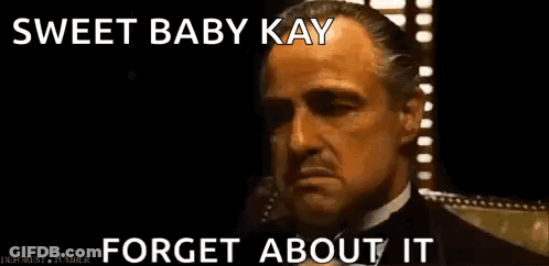 A Man In A Suit And Tie Is Talking On A Cell Phone And Says Sweet Baby Kay Forget About It . GIF