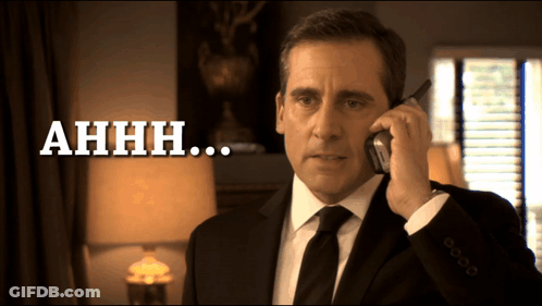 A Man In A Suit And Tie Is Talking On A Cell Phone And The Words Ahhh Are Below Him GIF