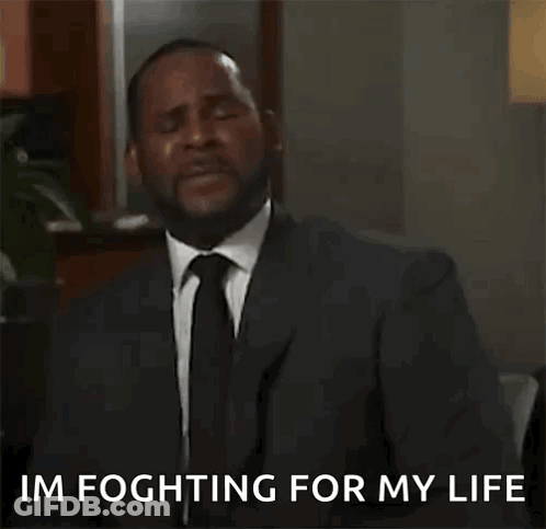 A Man In A Suit And Tie Is Talking On A Cell Phone While Dancing . GIF