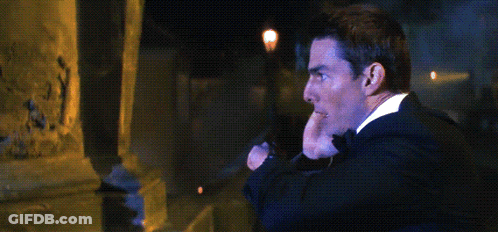 A Man In A Suit And Tie Is Talking On A Cell Phone With The Word Abort Written Above Him GIF