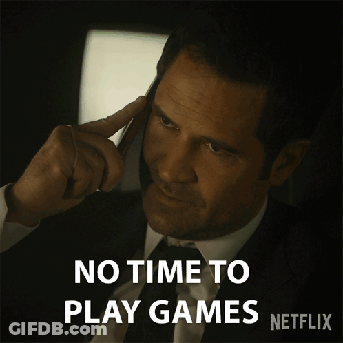 A Man In A Suit And Tie Is Talking On A Cell Phone With The Words " No Time To Play Games " Below Him GIF