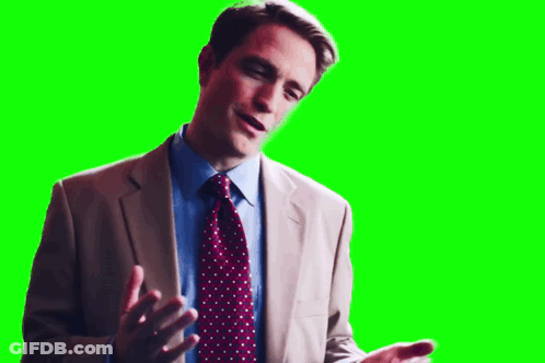 A Man In A Suit And Tie Is Talking On A Green Screen . GIF