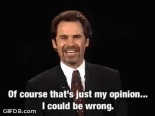 A Man In A Suit And Tie Is Talking On A Microphone . GIF