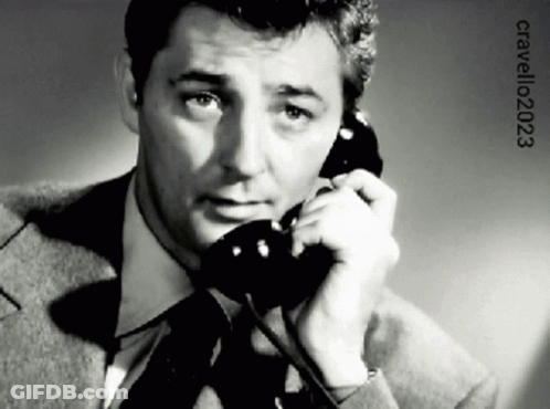 A Man In A Suit And Tie Is Talking On A Phone With The Year 2023 On The Bottom GIF
