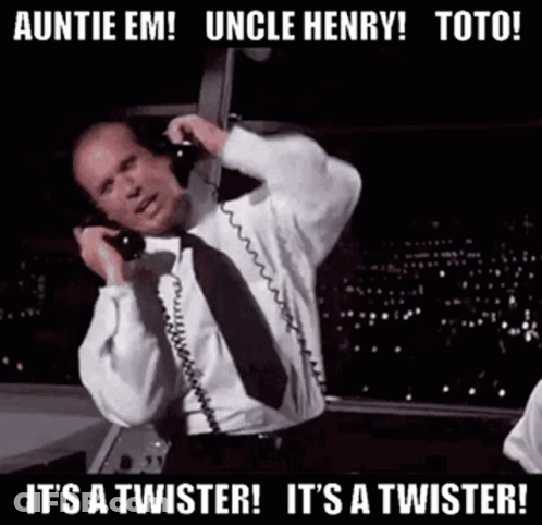 A Man In A Suit And Tie Is Talking On A Telephone While Dancing . GIF