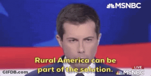 A Man In A Suit And Tie Is Talking On A Television Screen . GIF