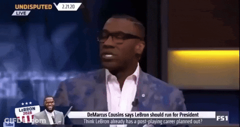 A Man In A Suit And Tie Is Talking On A Television Show GIF
