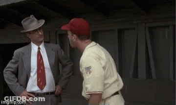 Man In Suit Talking To Baseball Player In Red Hat GIF