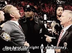 A Man In A Suit And Tie Is Talking To A Police Officer Who Says " You Have The Right To An Attorney " GIF