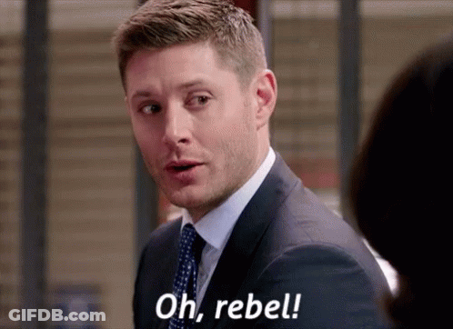 A Man In A Suit And Tie Is Talking To A Woman And Saying `` Oh , Rebel '' . GIF