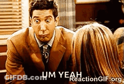 A Man In A Suit And Tie Is Talking To A Woman In A Restaurant . GIF