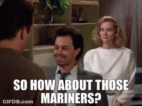 A Man In A Suit And Tie Is Talking To A Woman In A White Shirt While Another Man Looks On .. GIF